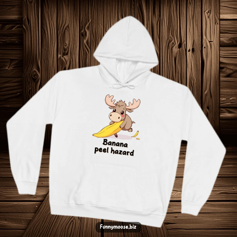 Funny hoodie showcasing a lovable, clumsy kawaii moose hilariously stumbling on a banana peel, its face a picture of adorable surprise.